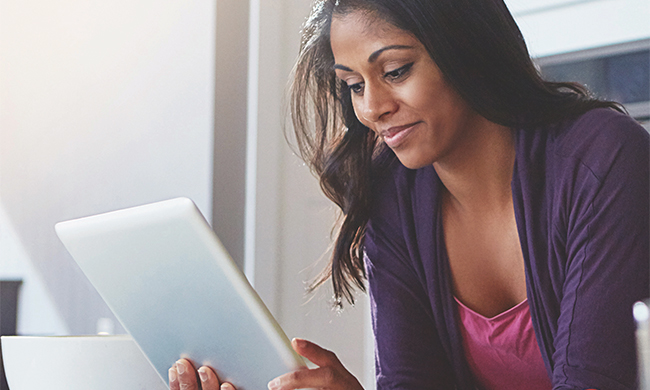 woman looking at tablet