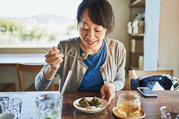 woman having a snack with some tea