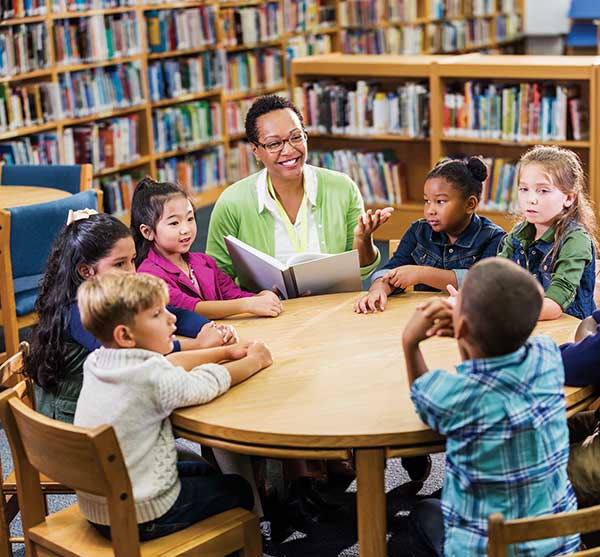 teacher with students in library