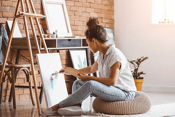 woman painting as self care
