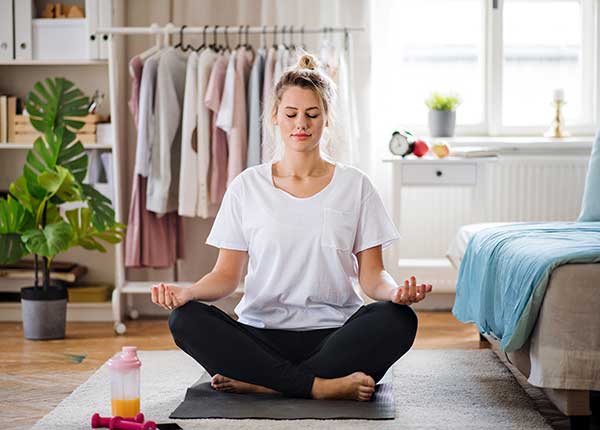 woman doing yoga as daily self care