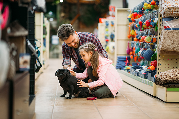 man and daughter at pet store with dog