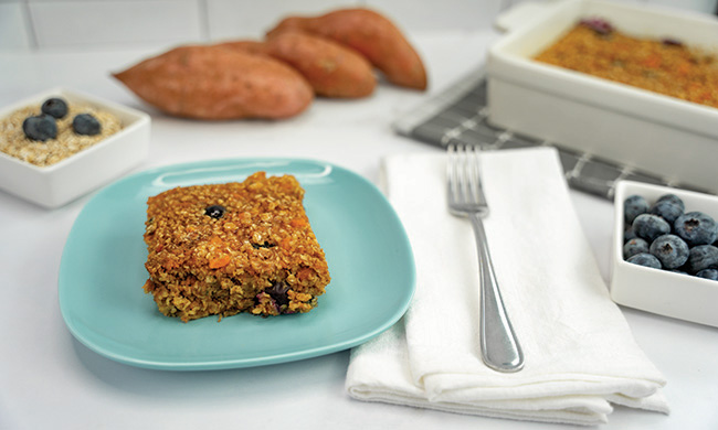 Ingredients for healthy breakfast recipe featuring mashed sweetpotato, rolled oats, fresh blueberries, eggs, and cinnamon