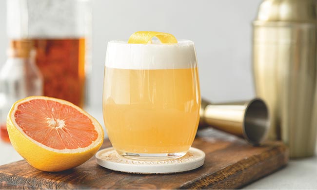 Grazing and Gifting: A festive display of Florida Citrus gift baskets filled with fresh tangerines, grapefruits, oranges, and mandarins, surrounded by holiday-themed recipes and drinks.